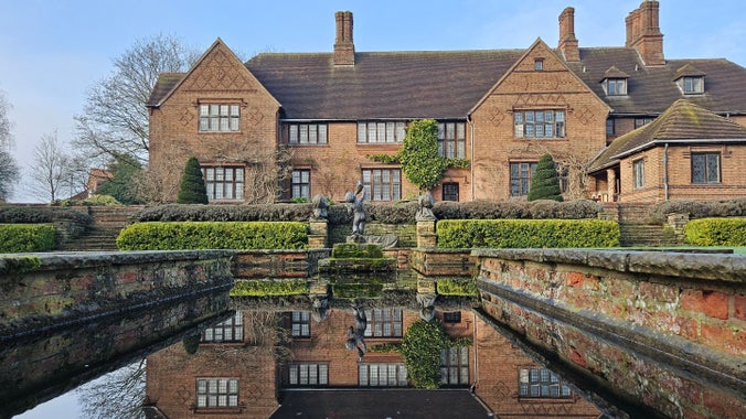 View of an Arts and Crafts house reflected in a still pond
